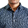 close up view of the collar and neck area of woven button up shirt in a navy floral pattern on a black male model