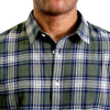 close up view of the collar and neck area of woven button up shirt in  green and off-white plaid on a black male model