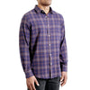 three quarters side view of men's long sleeve, slim fit,  navy plaid flannel button up shirt on a black model