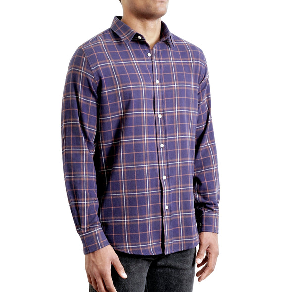 three quarters side view of men's long sleeve, slim fit,  navy plaid flannel button up shirt on a black model
