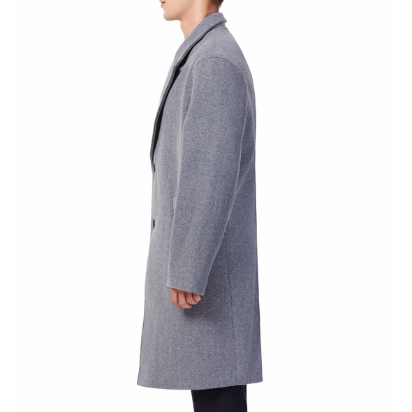 Men's long sleeve grey wool blend overcoat with 2 buttons at the front closer, large welt waist pockets and slightly oversized on a model - side view