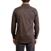 back view of a men's long sleeve, button up woven cotton dress shirt in a tan and white small print on black shirt. Worn by a black male model